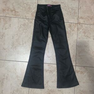Black flared jeans with 6 pockets, zipper and button closure and a 24” inseam